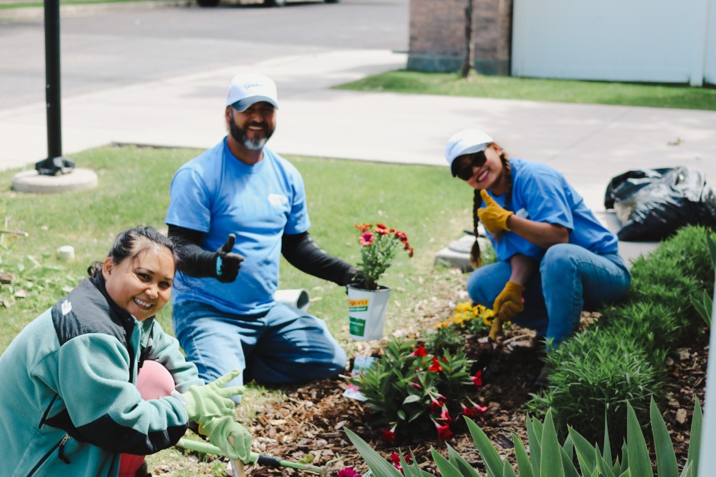Gossner employee volunteers are planting flowers in CAPSA's housing units flower beds
